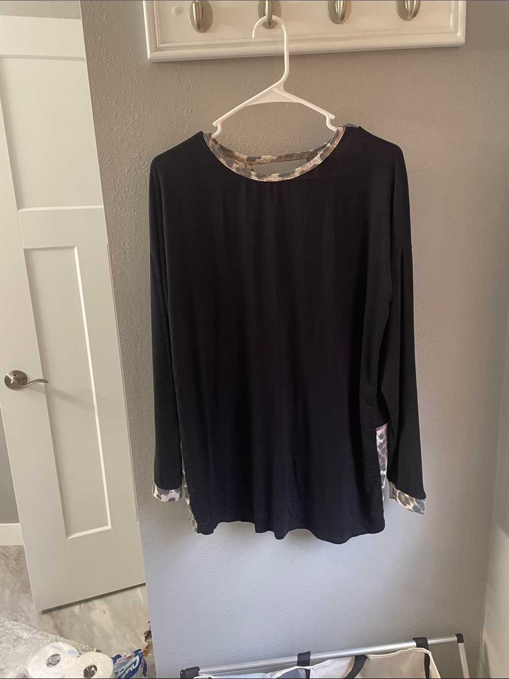 Black Long-Sleeve Women's Top with Leopard print trim.